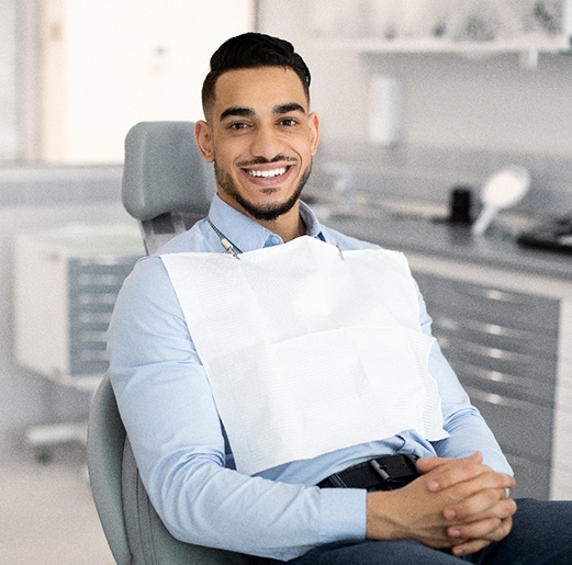 Patient smiling while sitting in treatment chair