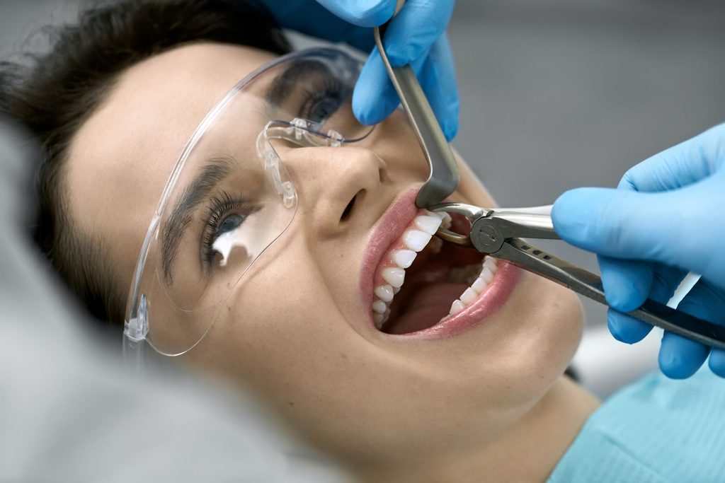 A woman getting a tooth extracted